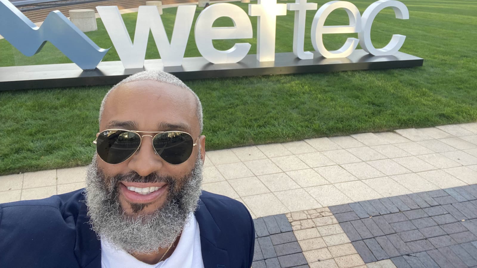 Tahir Charles in front of the WEFTEC sign at the water industry's annual technical conference